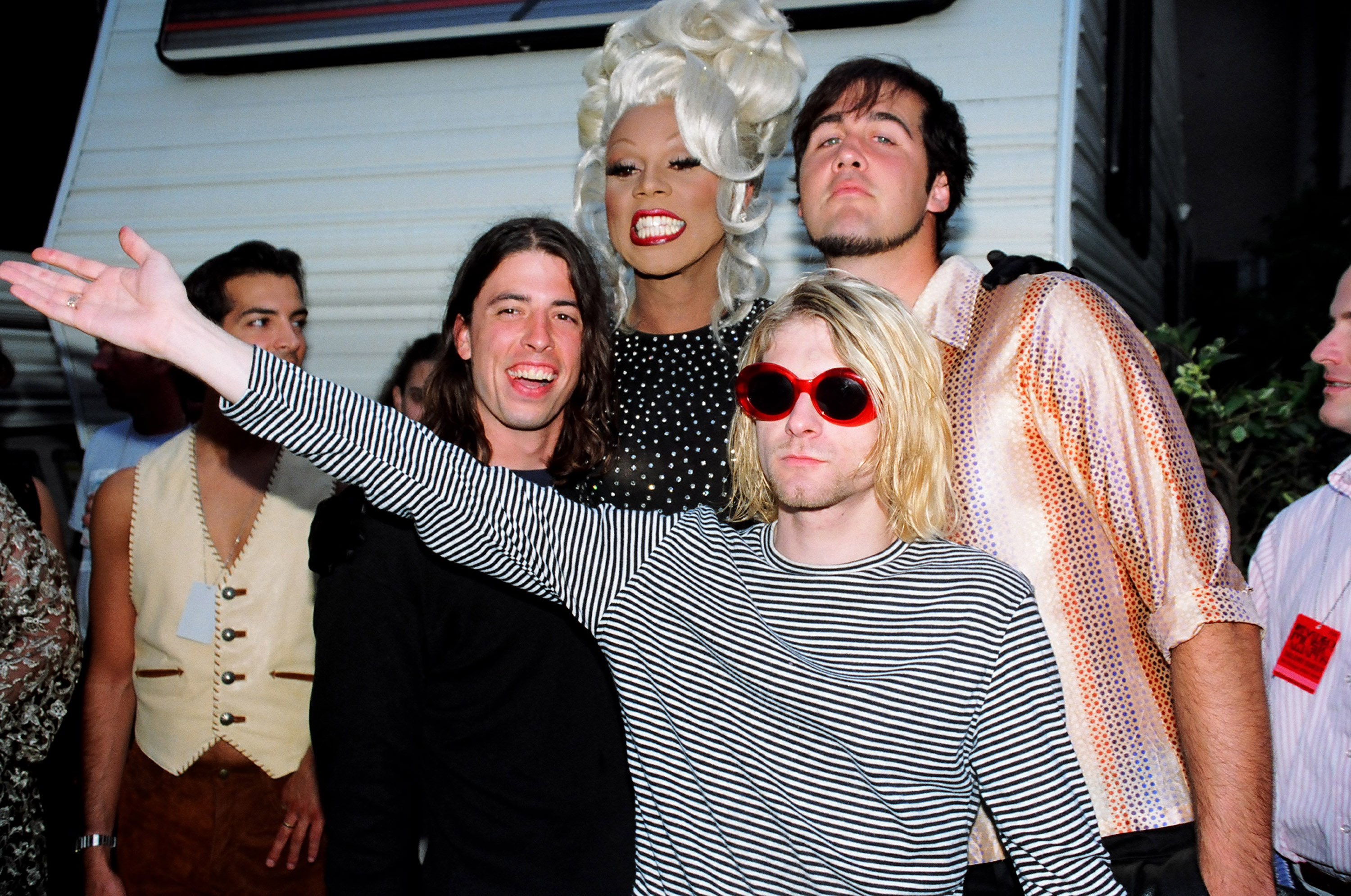 RuPaul (center) with Nrivana's Dave Grohl, Kurt Cobain and Krist Novoselic with a white background