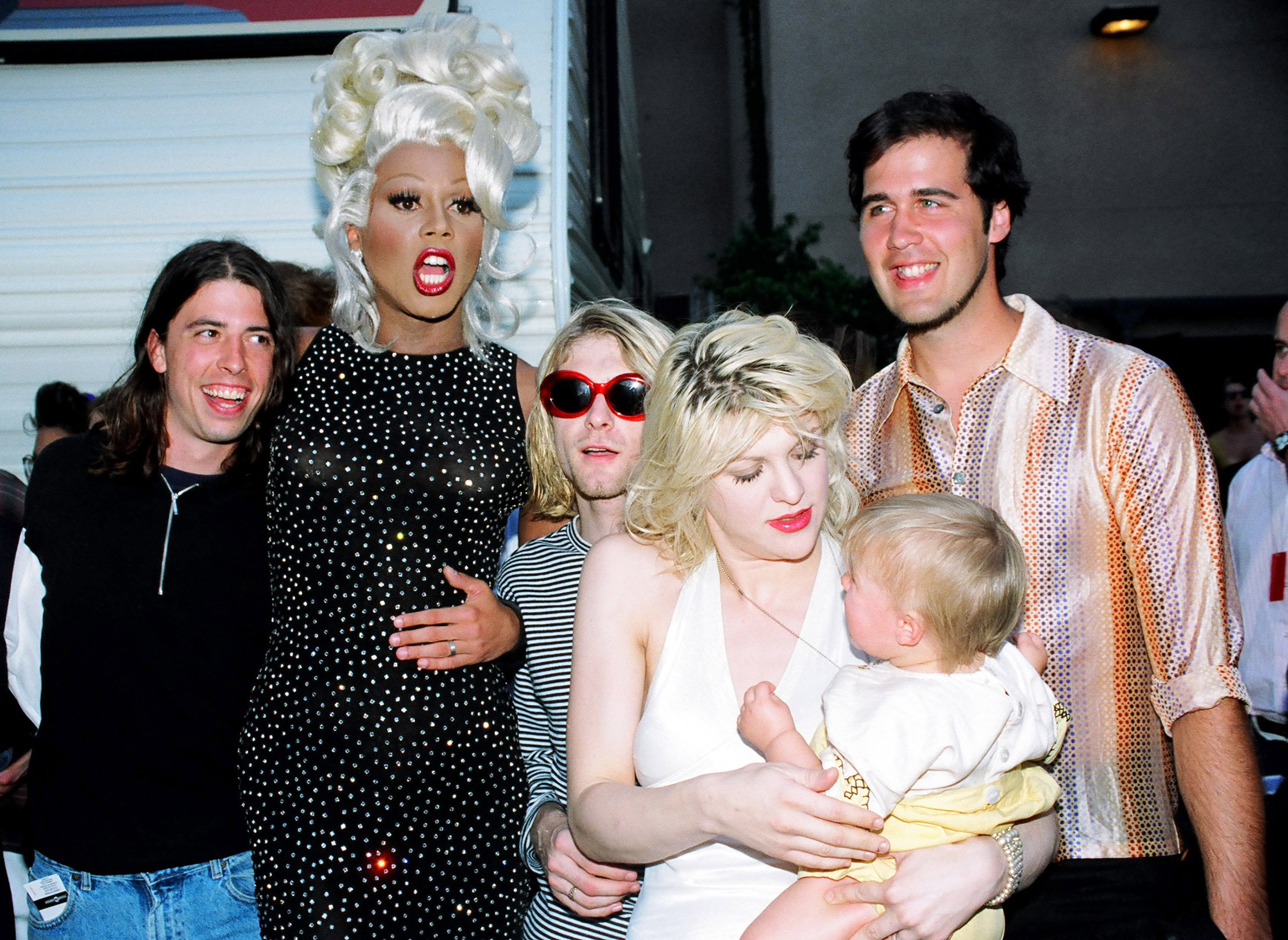 RuPaul with Dave Grohl, Kurt Cobain and Krist Novoselic of Nirvana, and Courtney Love with daughter Frances Bean Cobain standing in a row