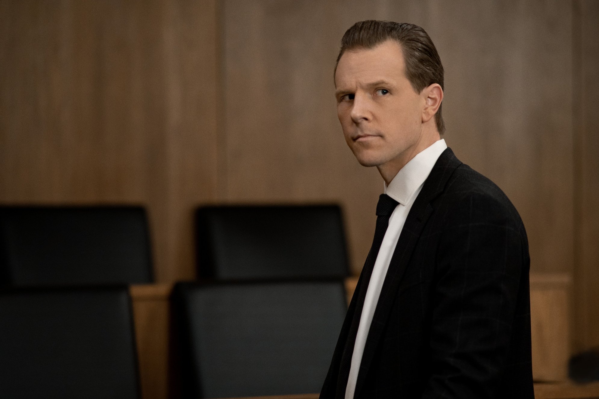 Shane Johnson as Cooper Saxe in a courtroom