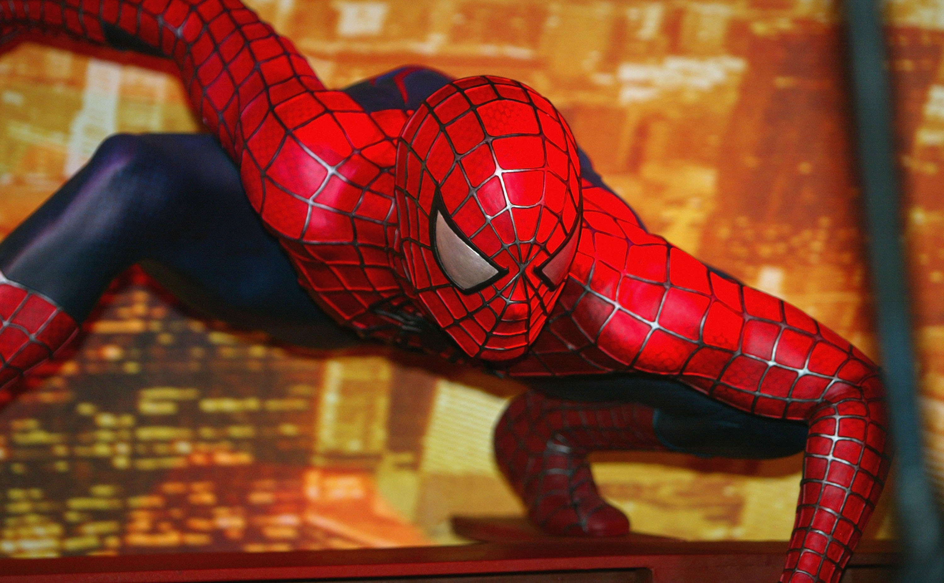 A wax figure of Spider-Man with one arm raised