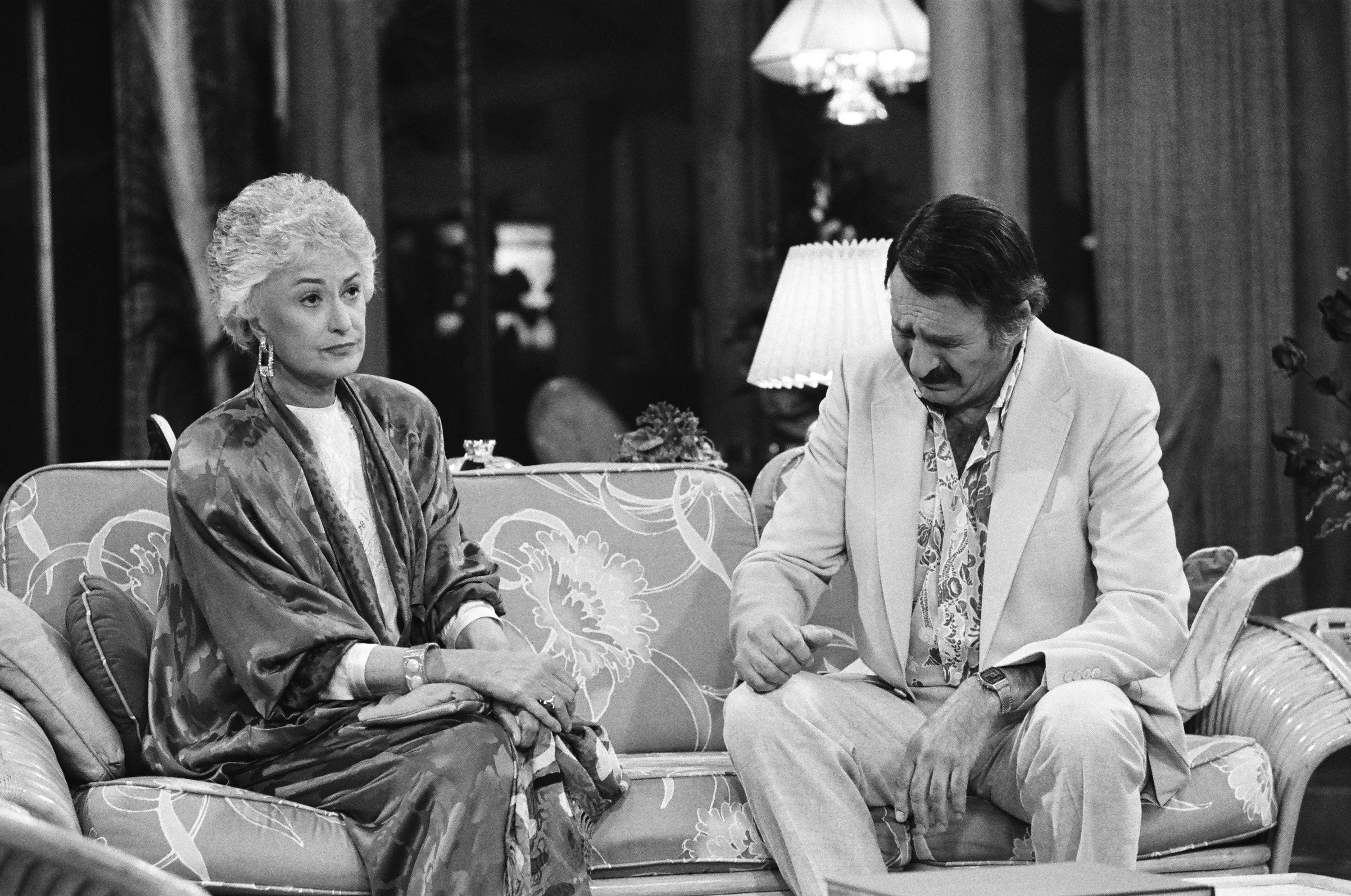 Bea Arthur as Dorothy Zbornak and Herb Edelman as Stan Zbornak talk in Dorothy's living room in an episode of 'The Golden Girls'