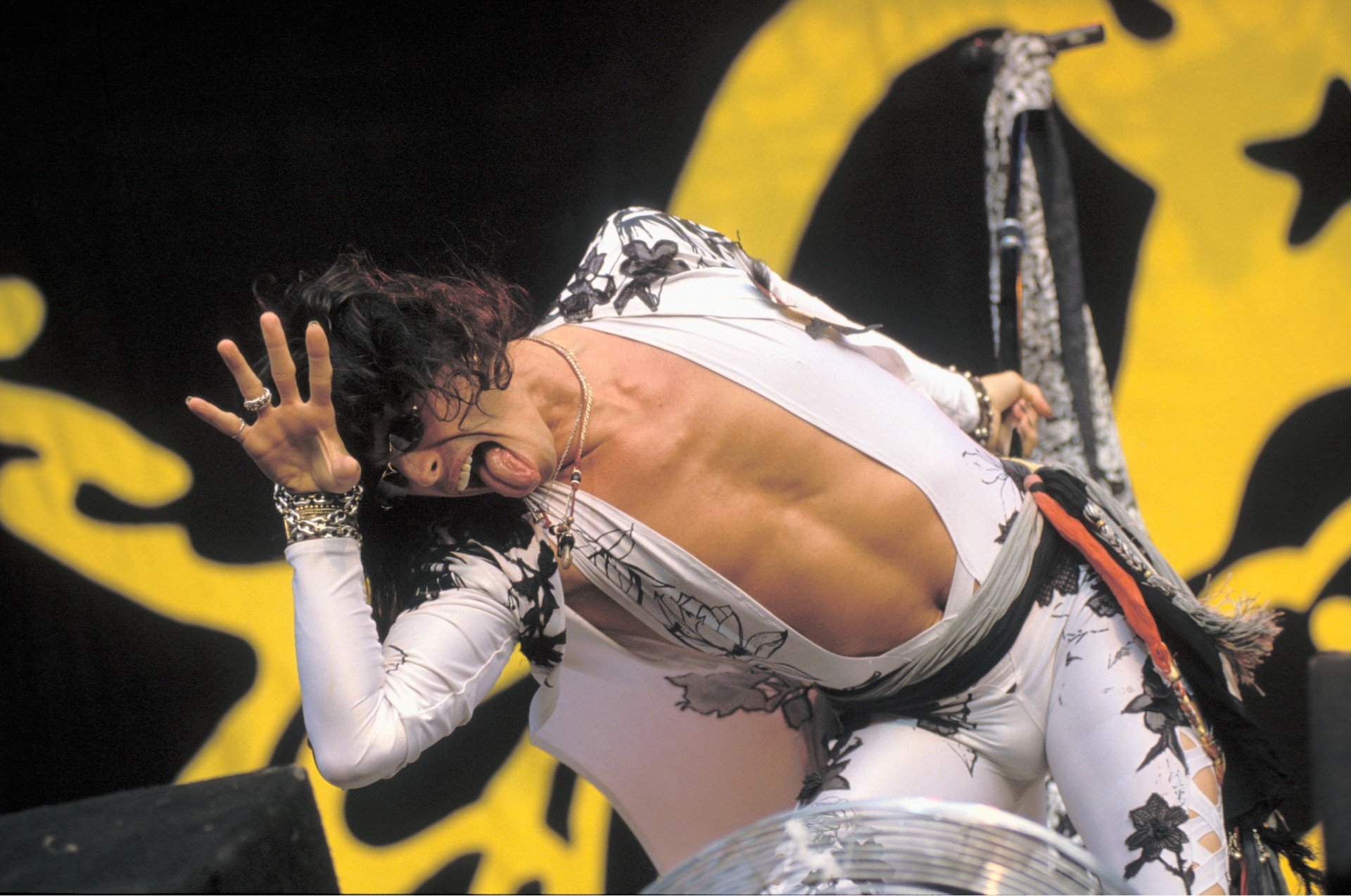 Steven Tyler in a white suit during a performance