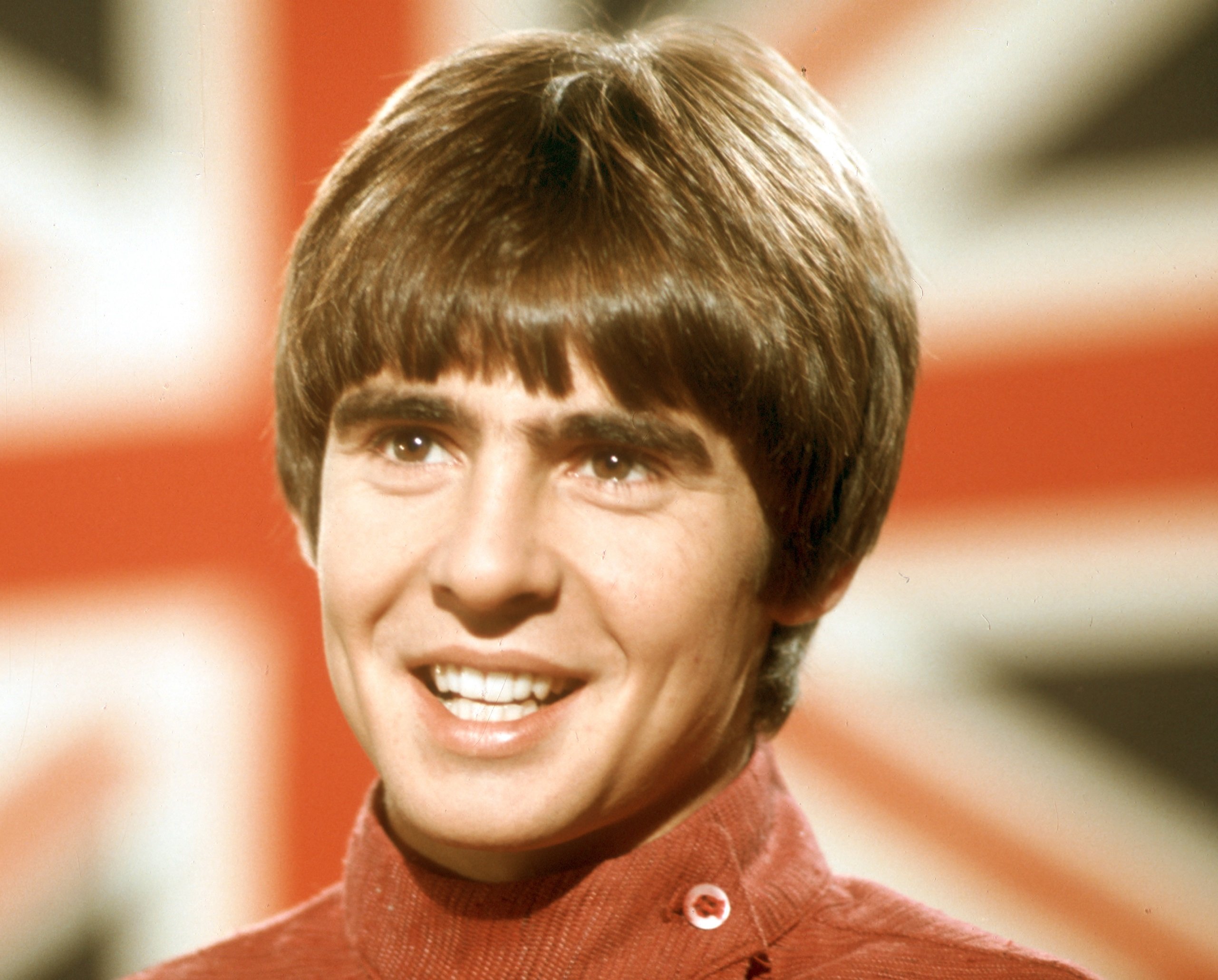 The Monkees' Davy Jones in front of the flag of the United Kingdom