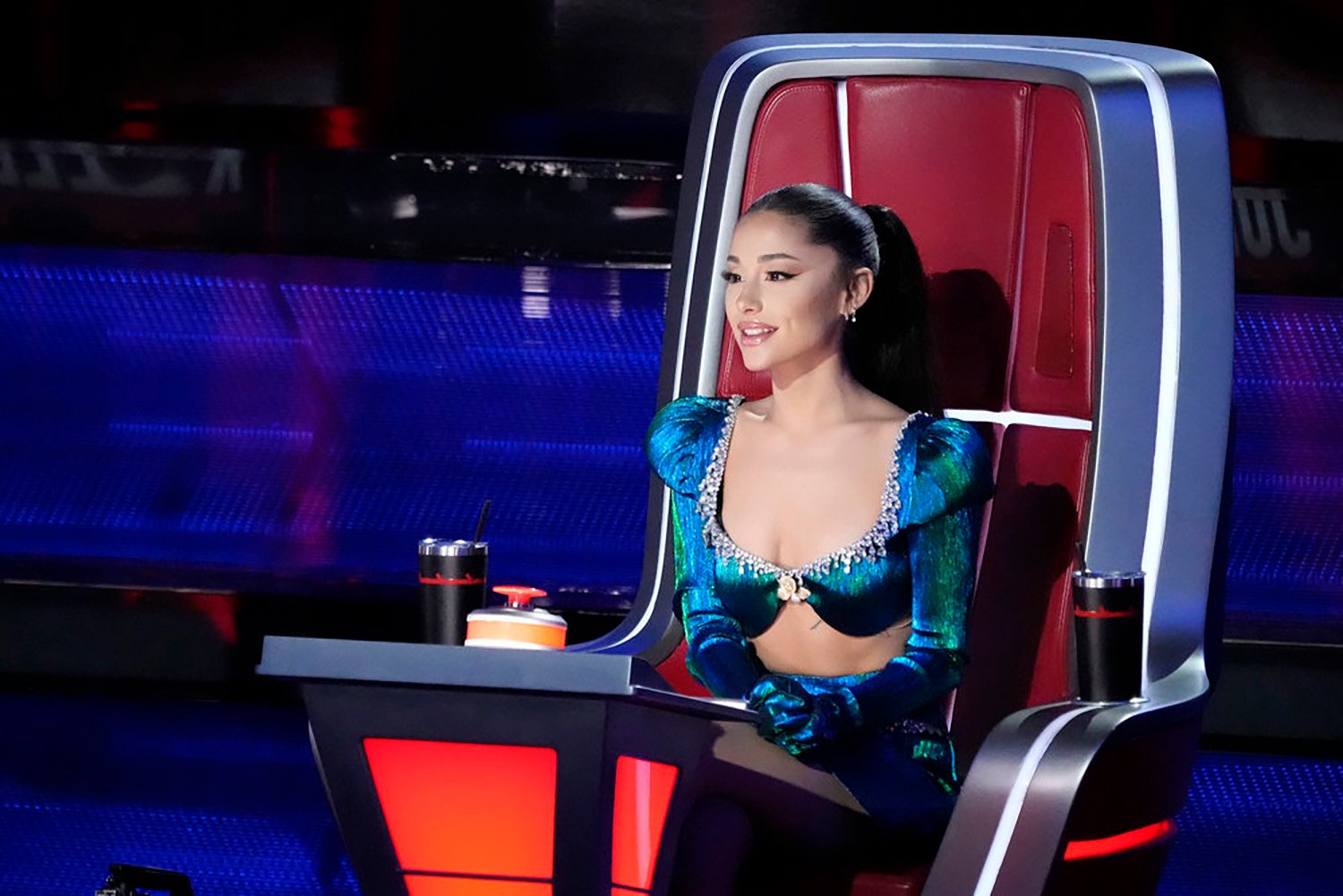 Ariana Grande sits in her chair during The Voice Season 21.