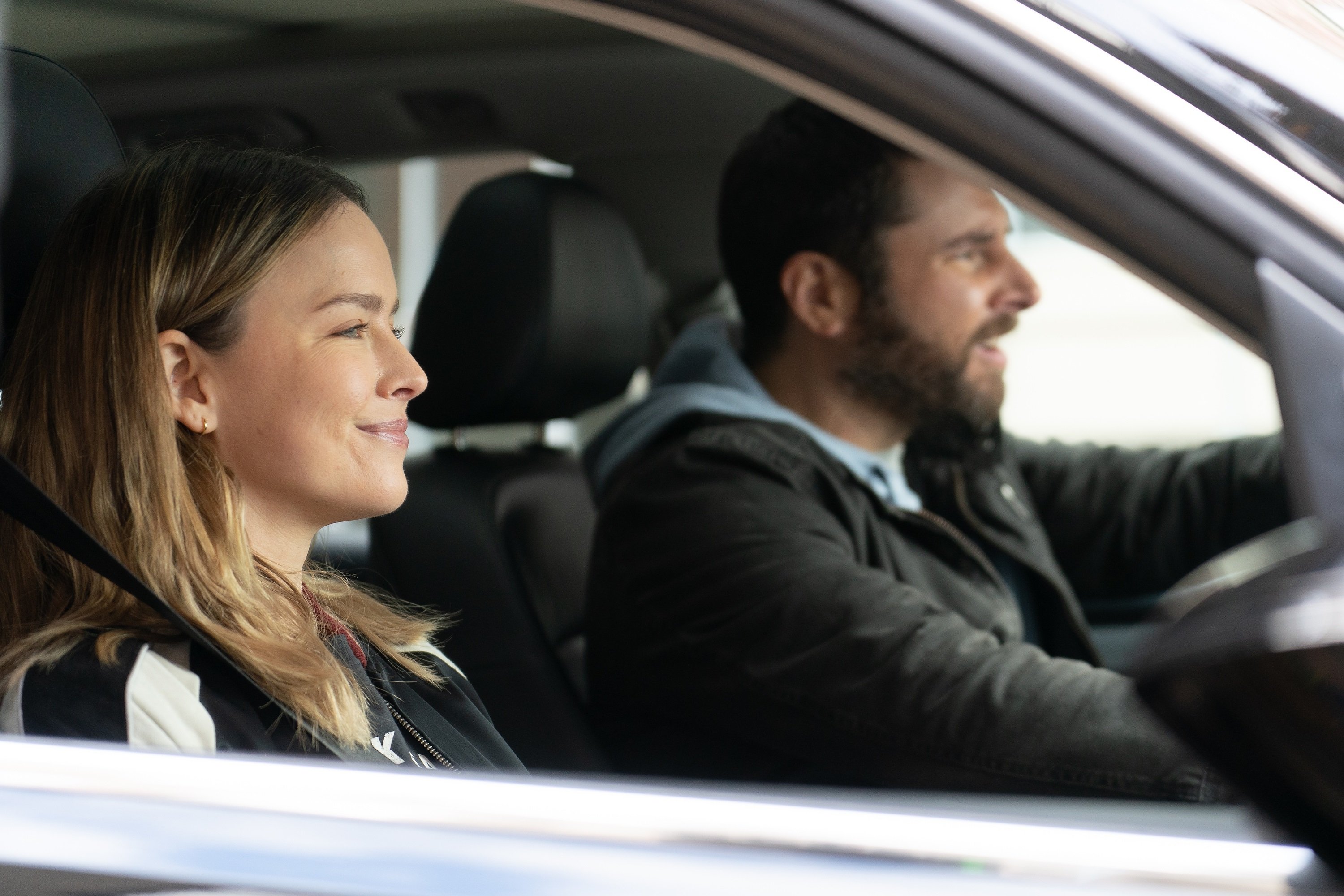 'A Million Little Things' cast members Allison Miller and James Roday Rodriguez driving in a car