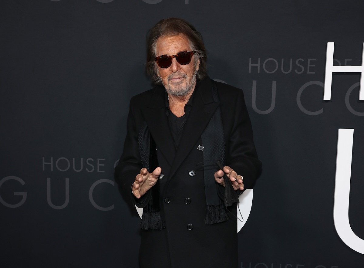 Al Pacino wearing a dark suit and shades.