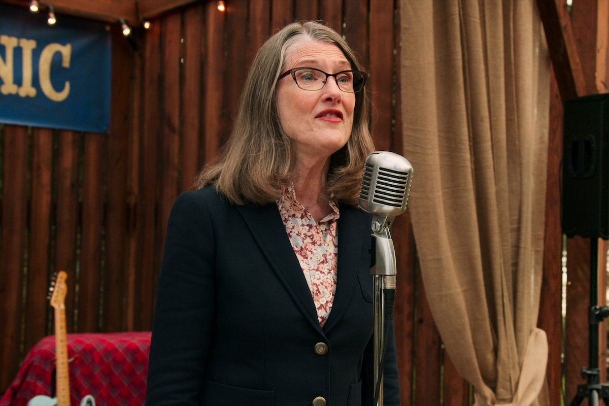 Annette O'Toole as Hope McCrea speaking into a microphone in 'Virgin River'