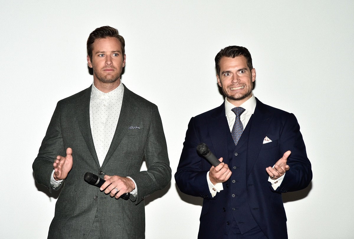 Henry Cavill and Armie Hammer posing in business suits.