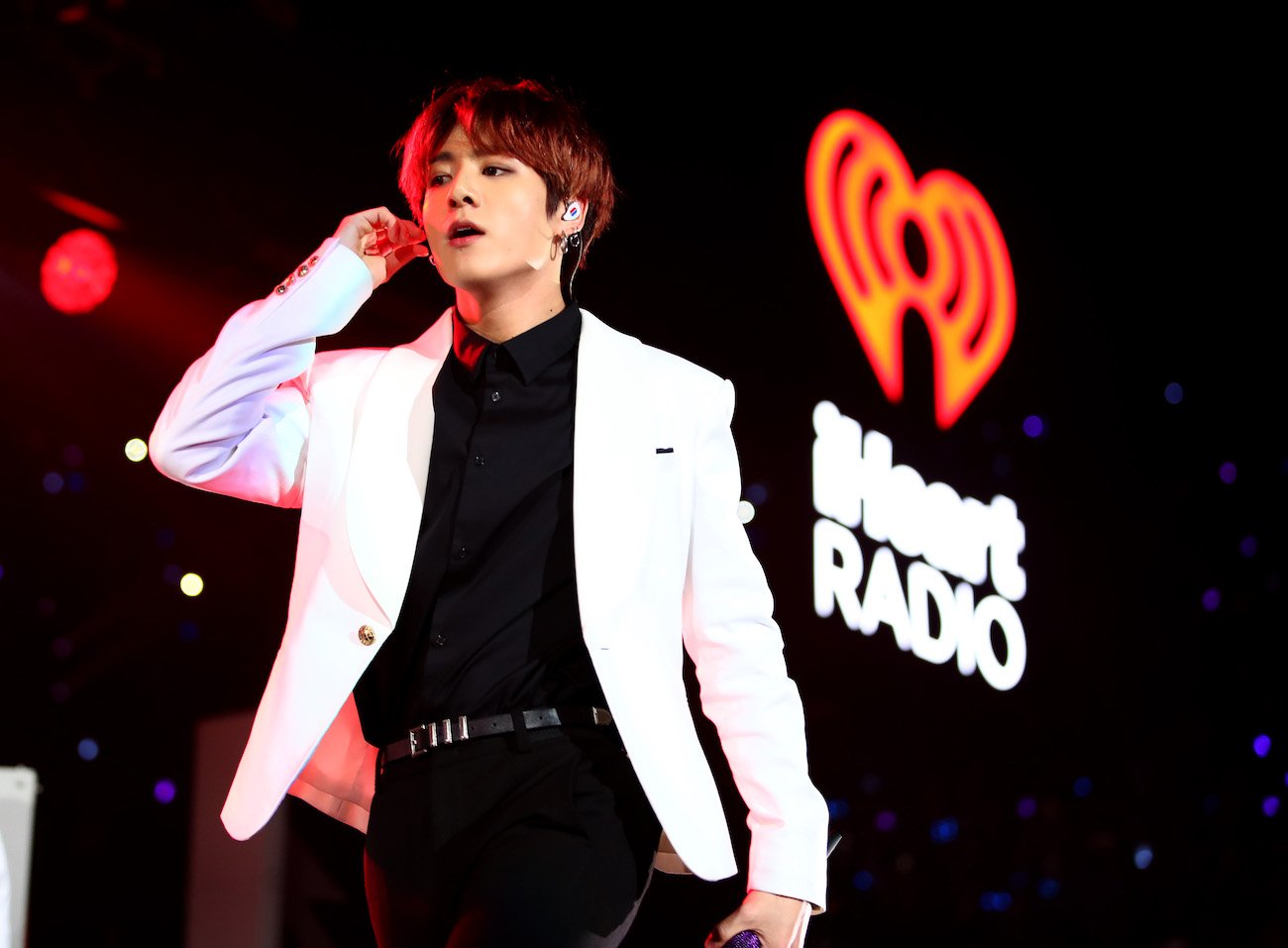 BTS's Jungkook on stage, touching his earpiece