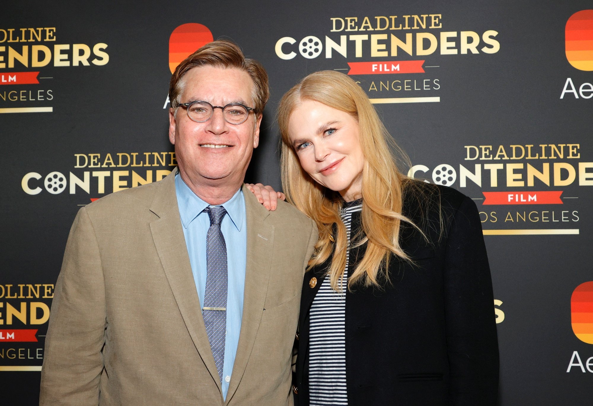 'Being the Ricardos' Aaron Sorkin and Nicole Kidman casting controversy smiling in front of a step and repeat