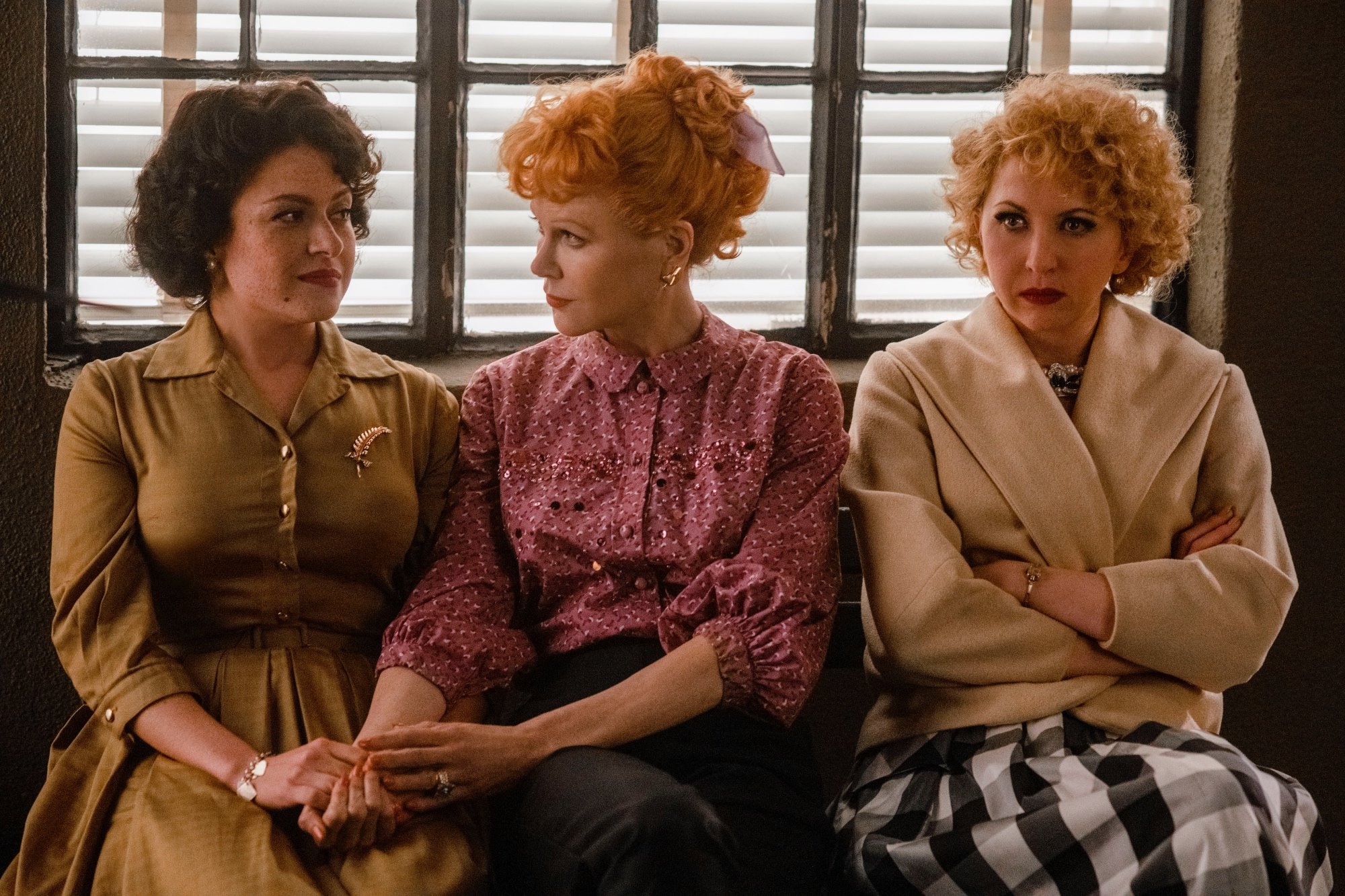 'Being the Ricardos' review Alia Shawkat as Madelyn Pugh, Nicole Kidman as Lucille Ball, and Nina Arianda as Vivian Vance sitting on a bench