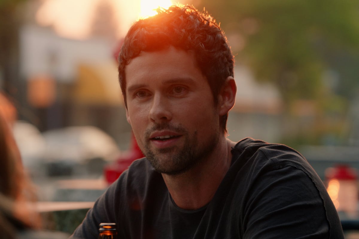 Ben Hollingsworth as Dan Brady sitting in the sunlight in 'Virgin River'