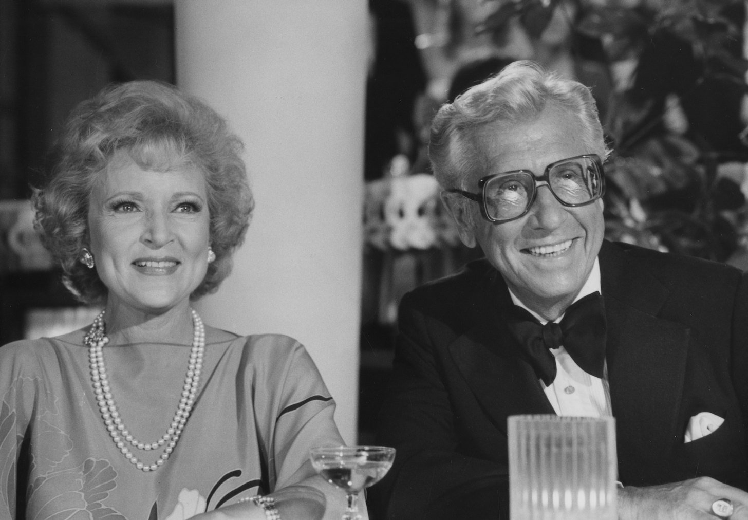 Betty White stepchildren are from Allen Ludden. Here is a black-and-white photo of Betty White and Allen Ludden sitting next to each other and smiling.