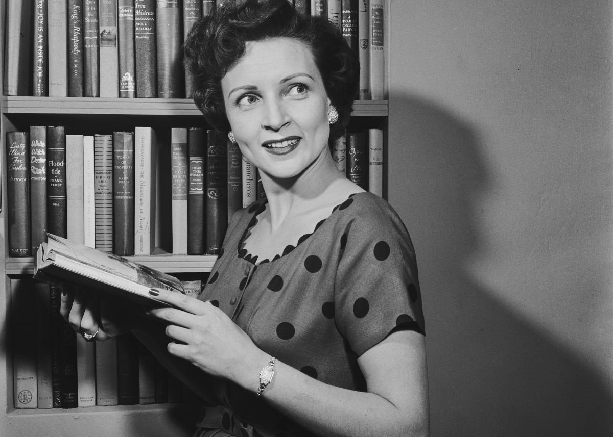 Betty White holds an open book and looks away, c. 1954