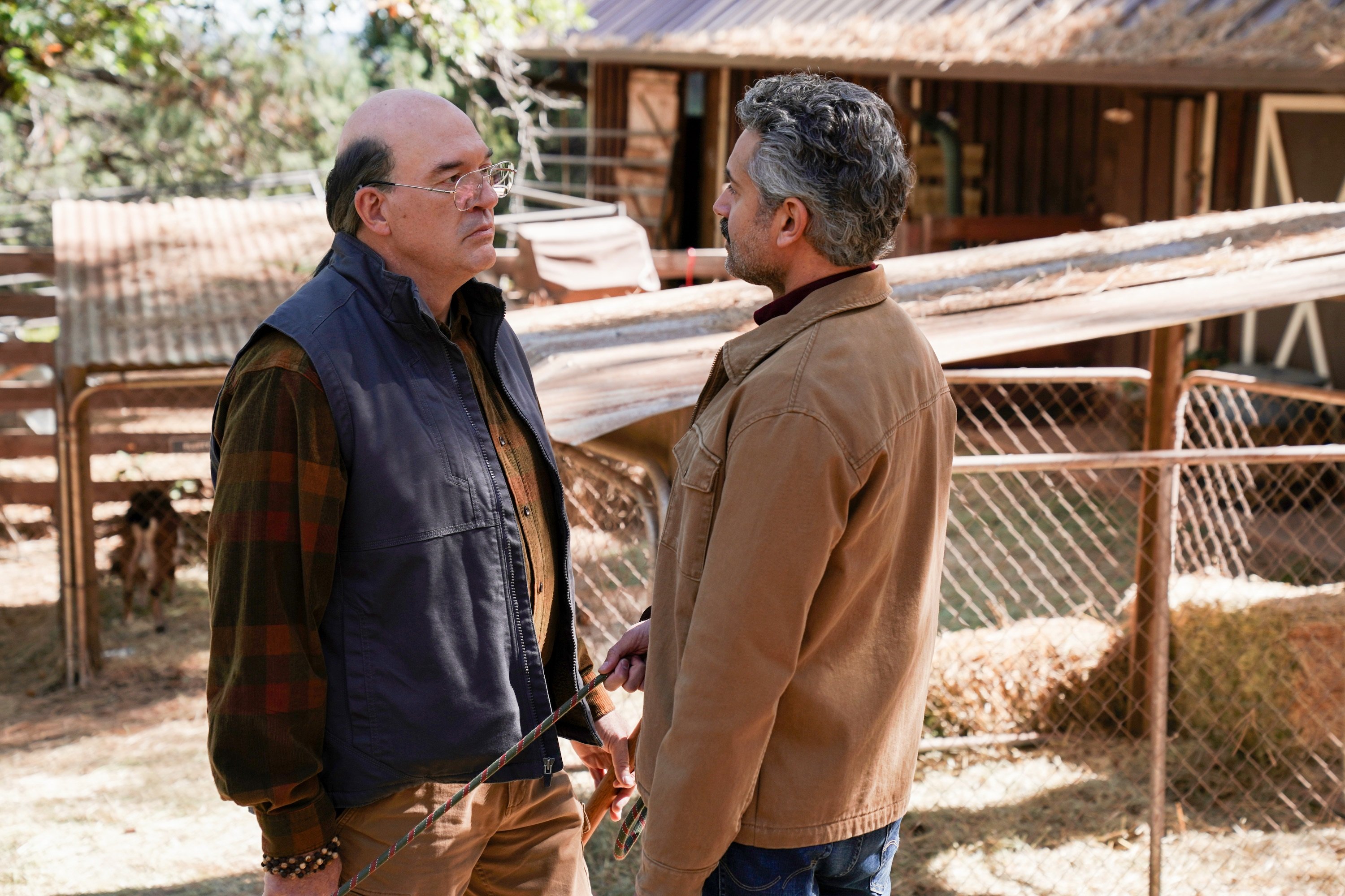 'Big Sky' John Carroll Lynch stares at Omar Metwally as they portray Wolf Legarski and Mark Lindor