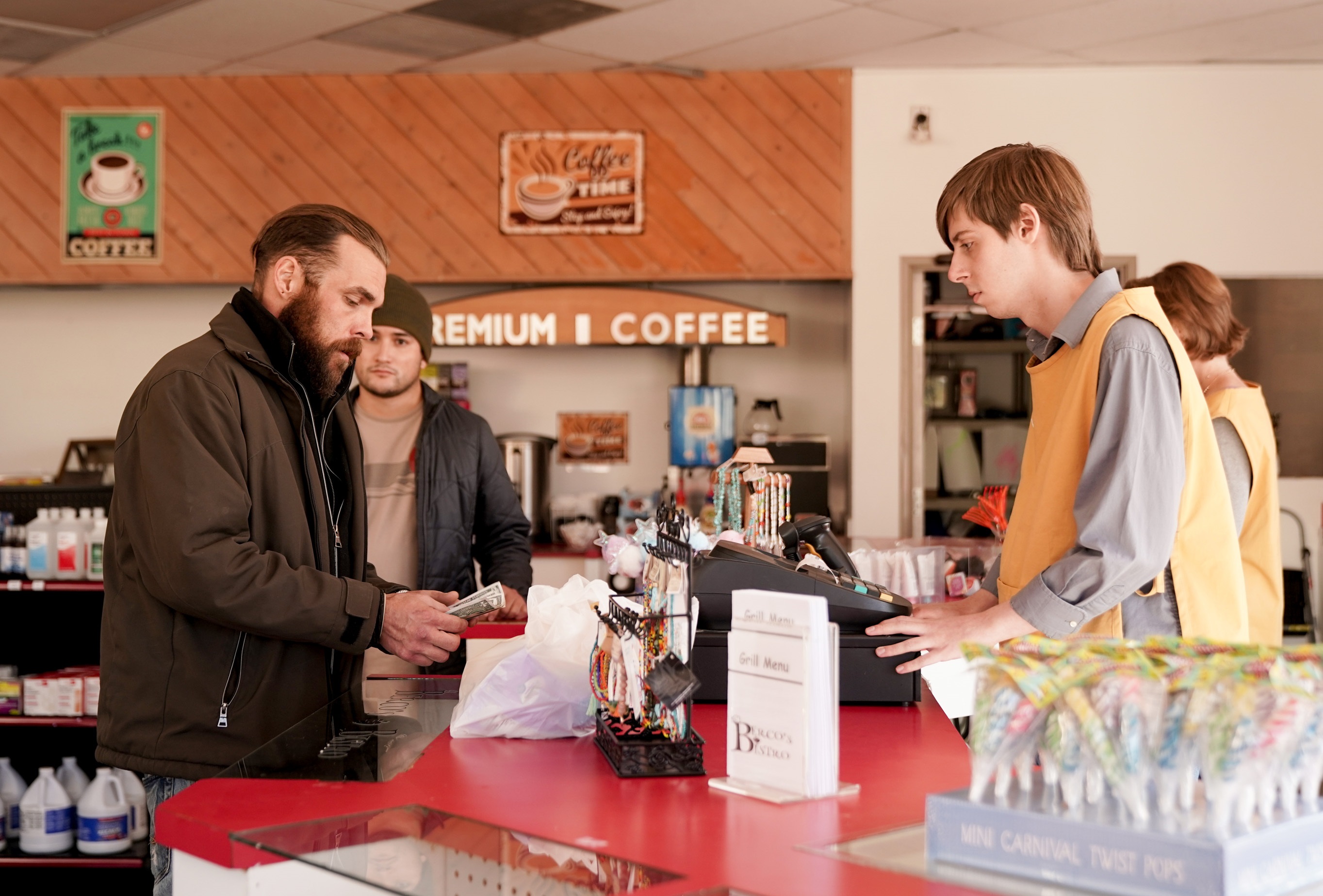 'Big Sky' Ramiro Montanez watching Ryan O'Nan at the cash register