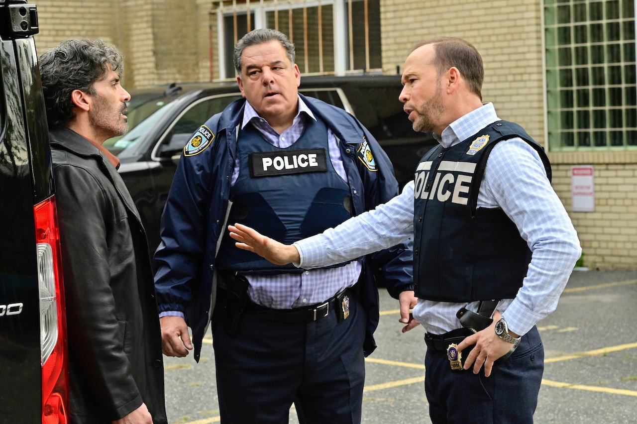 Anthony DeSando as Cousin Joey Ruscoli talks to Steven Schirripa as Anthony Abetamarco and Donnie Wahlberg as Danny Reagan who are in police bullet proof vests on 'Blue Bloods'.