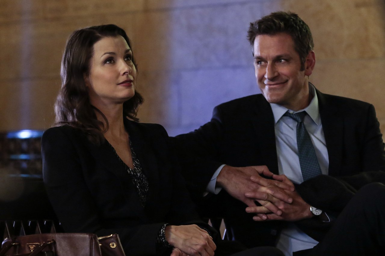 Bridget Moynahan as Erin Reagan and Peter Hermann as Jack Boyle sit next to each other on 'Blue Bloods'