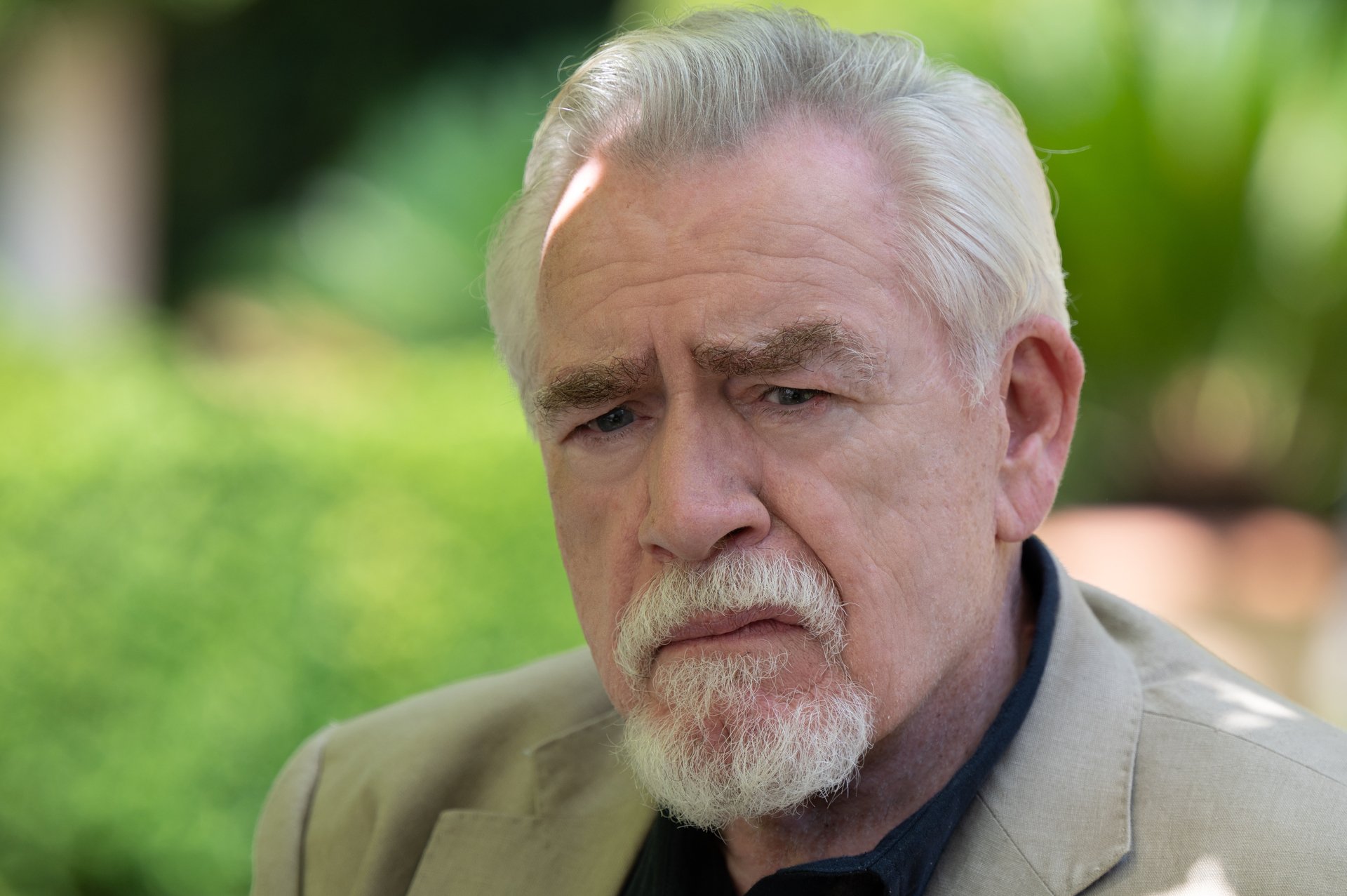 Brian Cox as Logan Roy in 'Succession' Season 3. There's greenery behind him, and he looks like he's thinking.