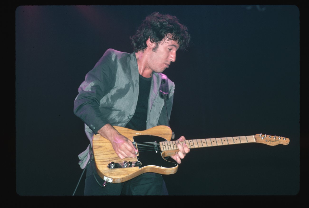 Bruce Springsteen performing on stage wearing a blazer in 1978.