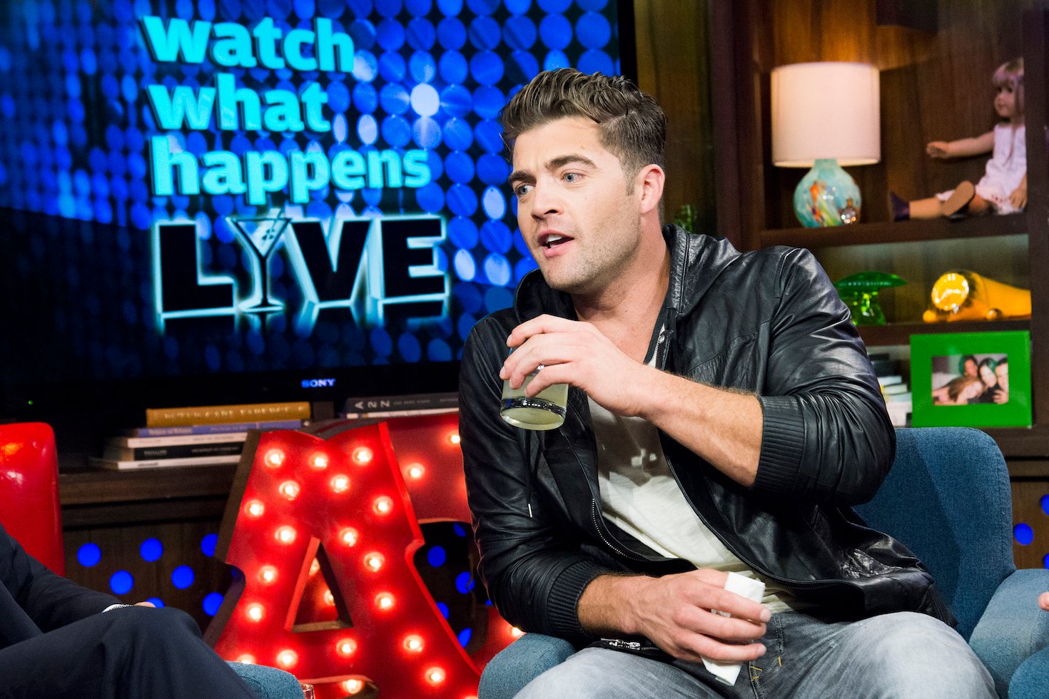CT Tamburello from MTV's 'The Challenge' Season 37 sitting on a couch and taking a drink of water on 'Watch What Happens Live.' 
