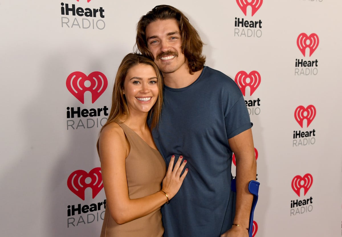 (L-R) Caelynn Miller-Keyes and Dean Unglert smiling in front of a white background