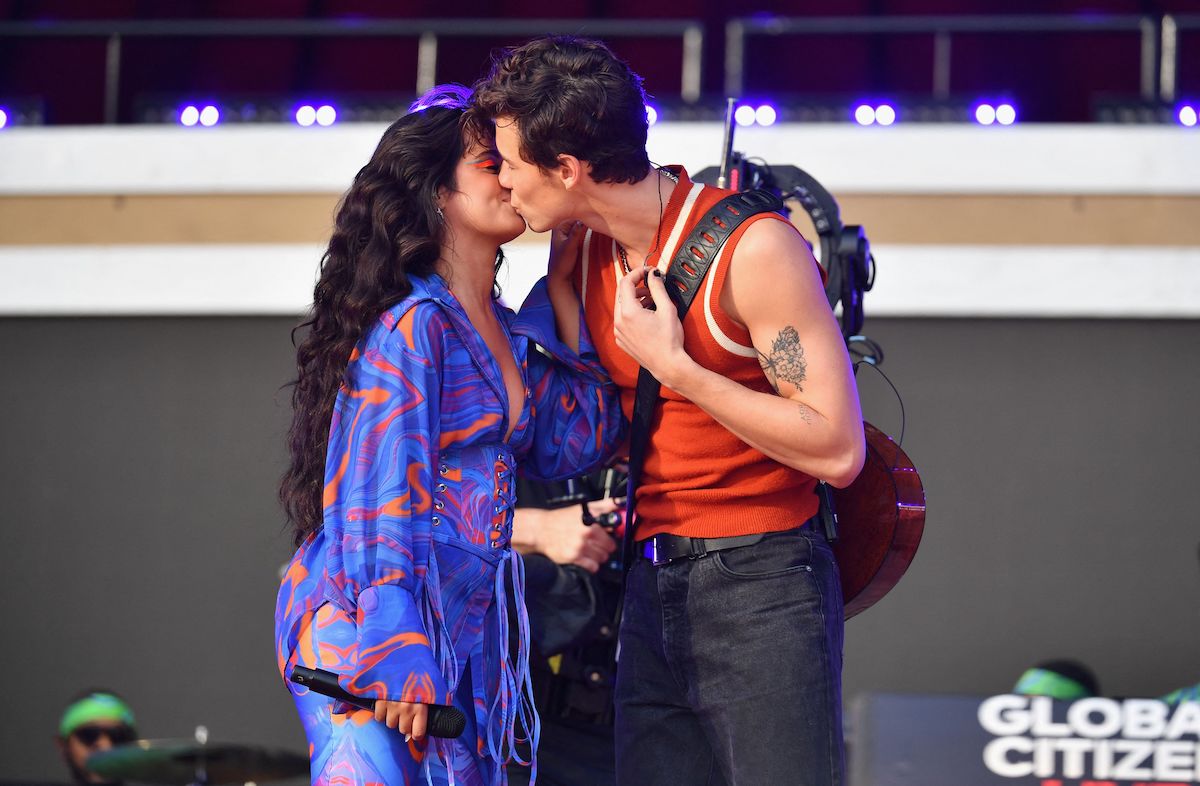 Camila Cabello and Shawn Mendes kiss on stage.
