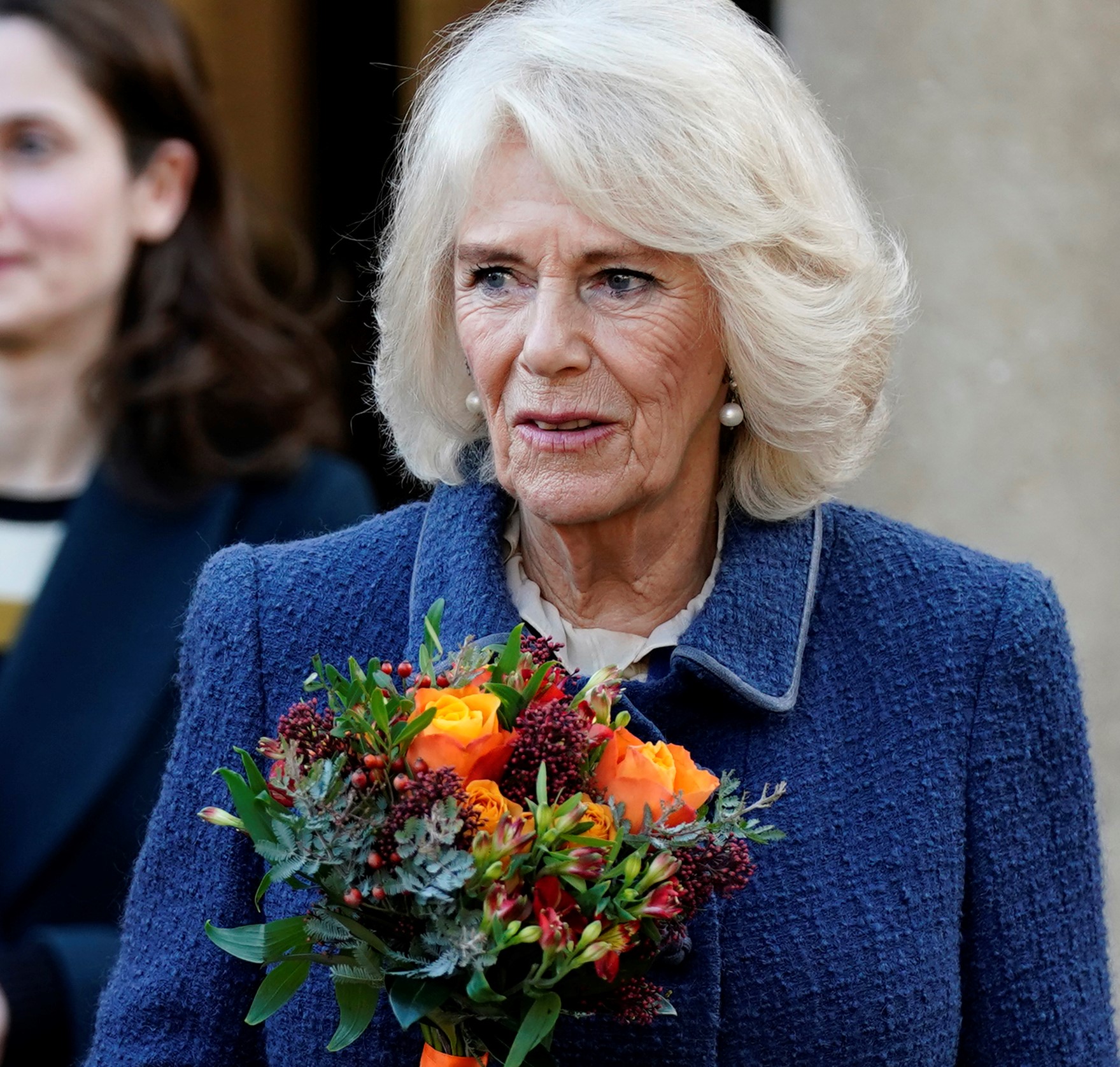 Camilla holding a bouquet during a visit to the newly converted Parade Cinema