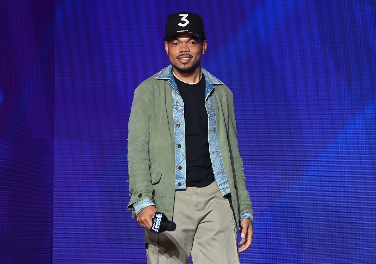 Chance the Rapper smiling and wearing a black cap