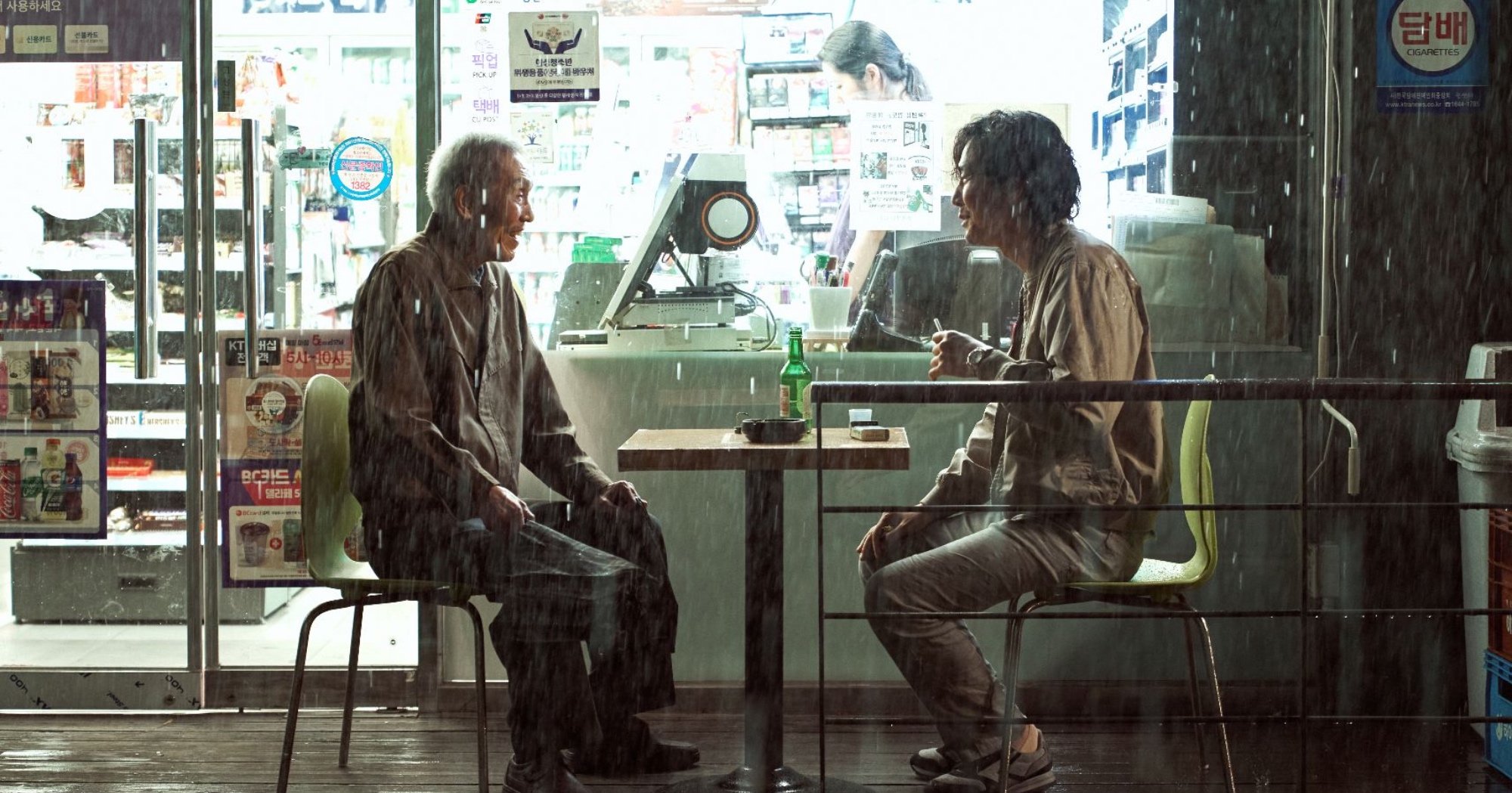 Characters Il-nam and Gi-hun in 'Squid Game' K-drama theory while sitting outside convenience store.