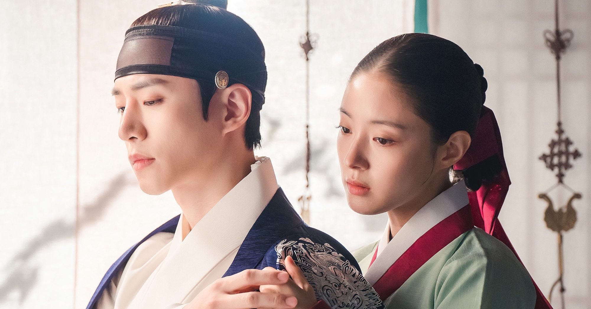 Characters Yi San and Deok-im from 'The Red Sleeve' wearing traditional Korean clothing.