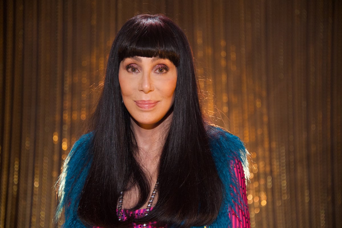 Cher poses against a backdrop.