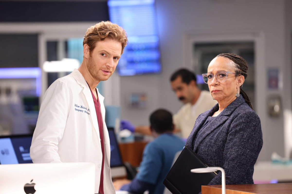 Nick Gehlfuss as Dr. Will Halstead and S. Epatha Merkerson as Sharon Goodwin in Chicago Med Season 7. The pair look concerned about something.