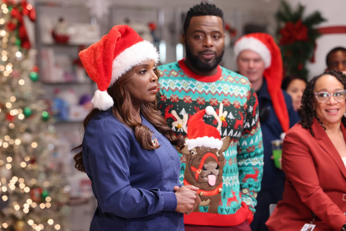 Marlyne Barrett as Maggie and Guy Lockard as Dr. Dylan Scott in the Chicago Med Season 7 fall finale. Maggie is wearing and Santa hat and Dr. Scott is wearing a holiday sweater.