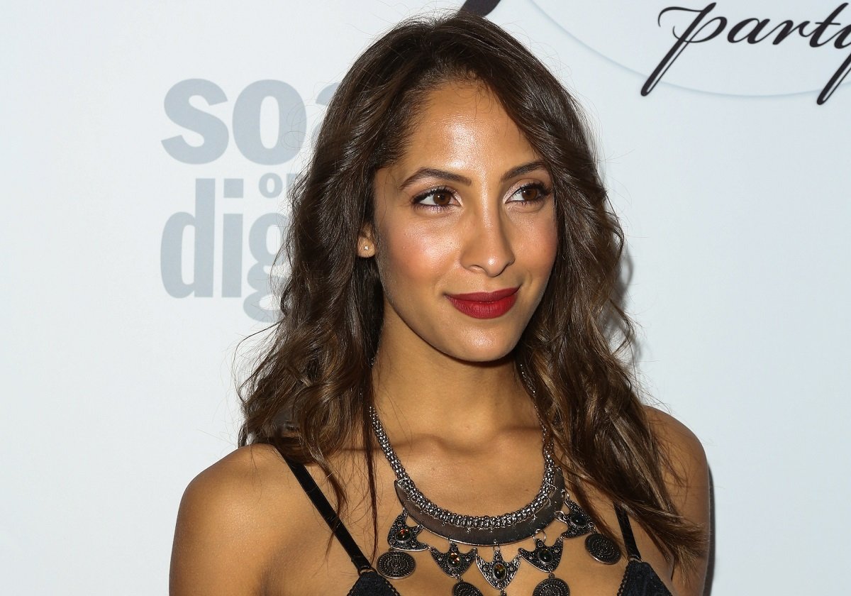 'The Young and the Restless' actor Christel Khalil wearing a black dress and red lipstick.