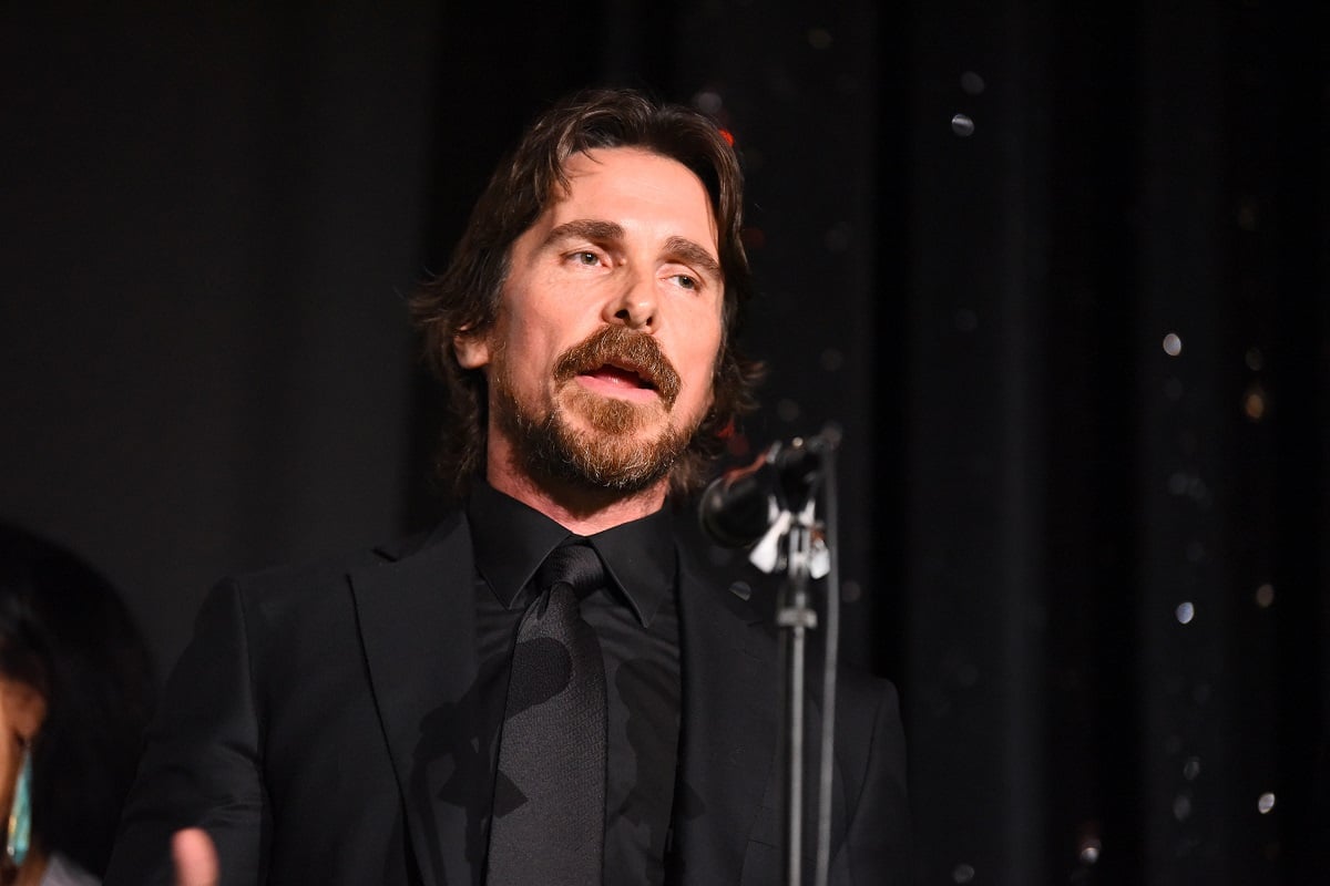 Christian Bale posing while on stage.