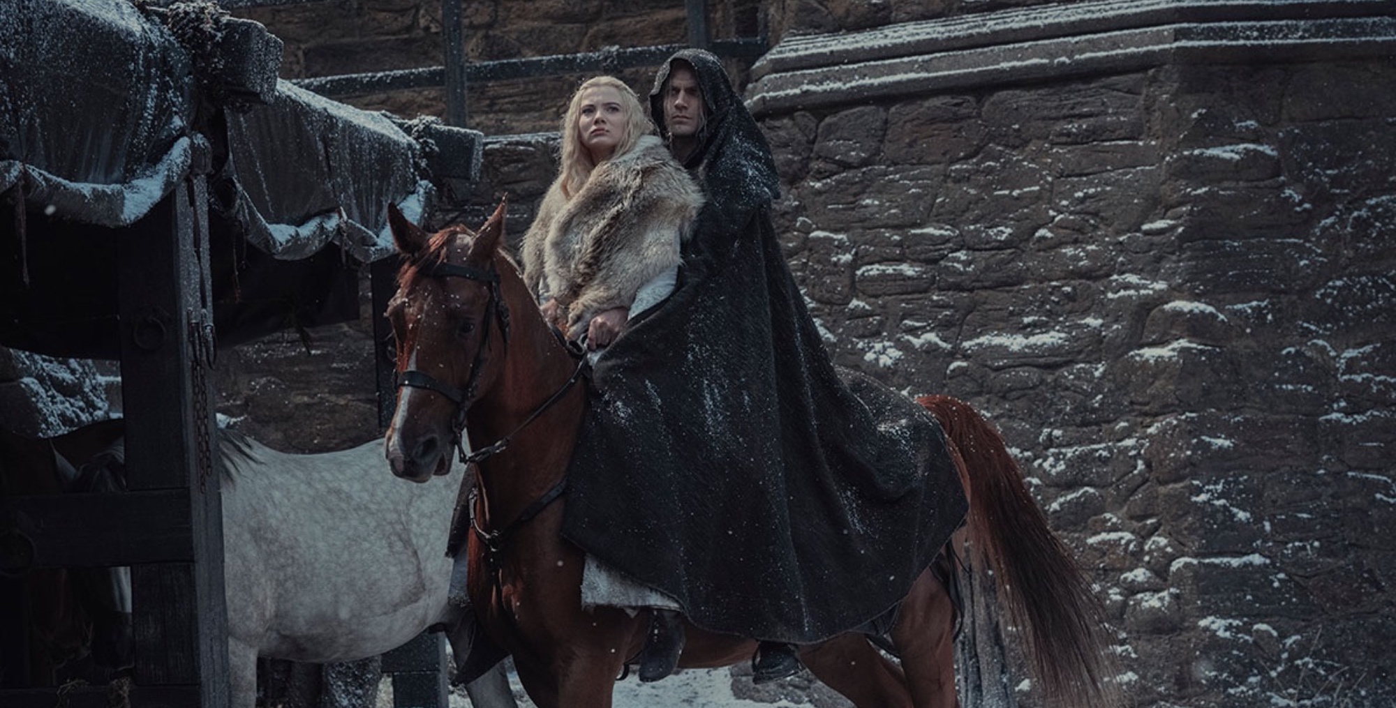 Ciri, Geralt and Roach in 'The Witcher' Season 2 wearing cloaks on top of horse.