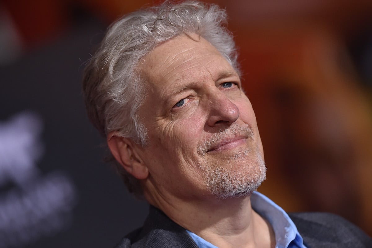 Clancy Brown wears a dark-colored suit on the red carpet at an event