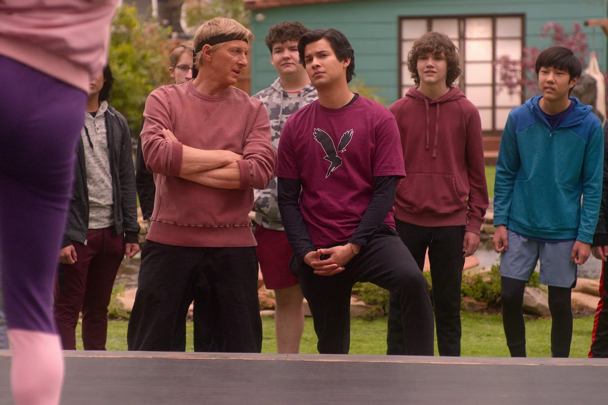 'Cobra Kai' Season 4: Johnny folds his arms and Miguel interlocks his fingers