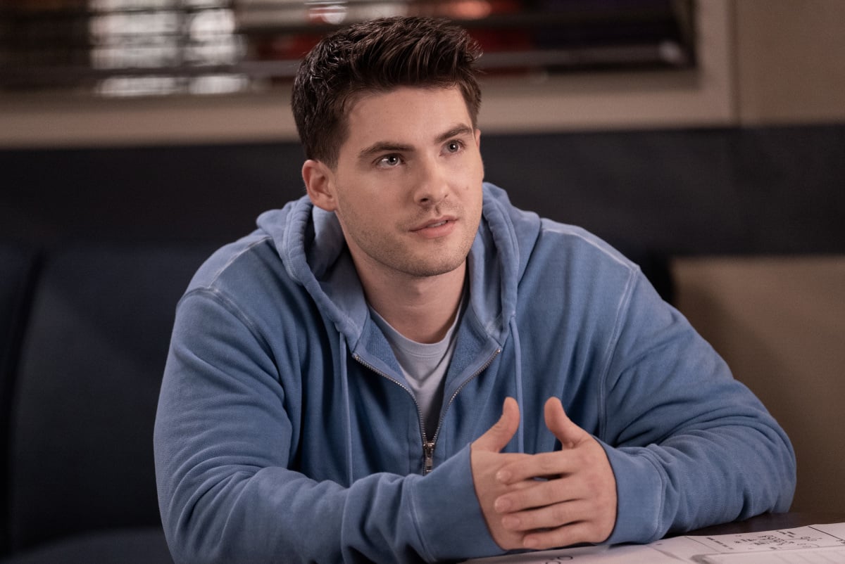 Cody Christian is wearing a bright blue hoodie in 'All American.'