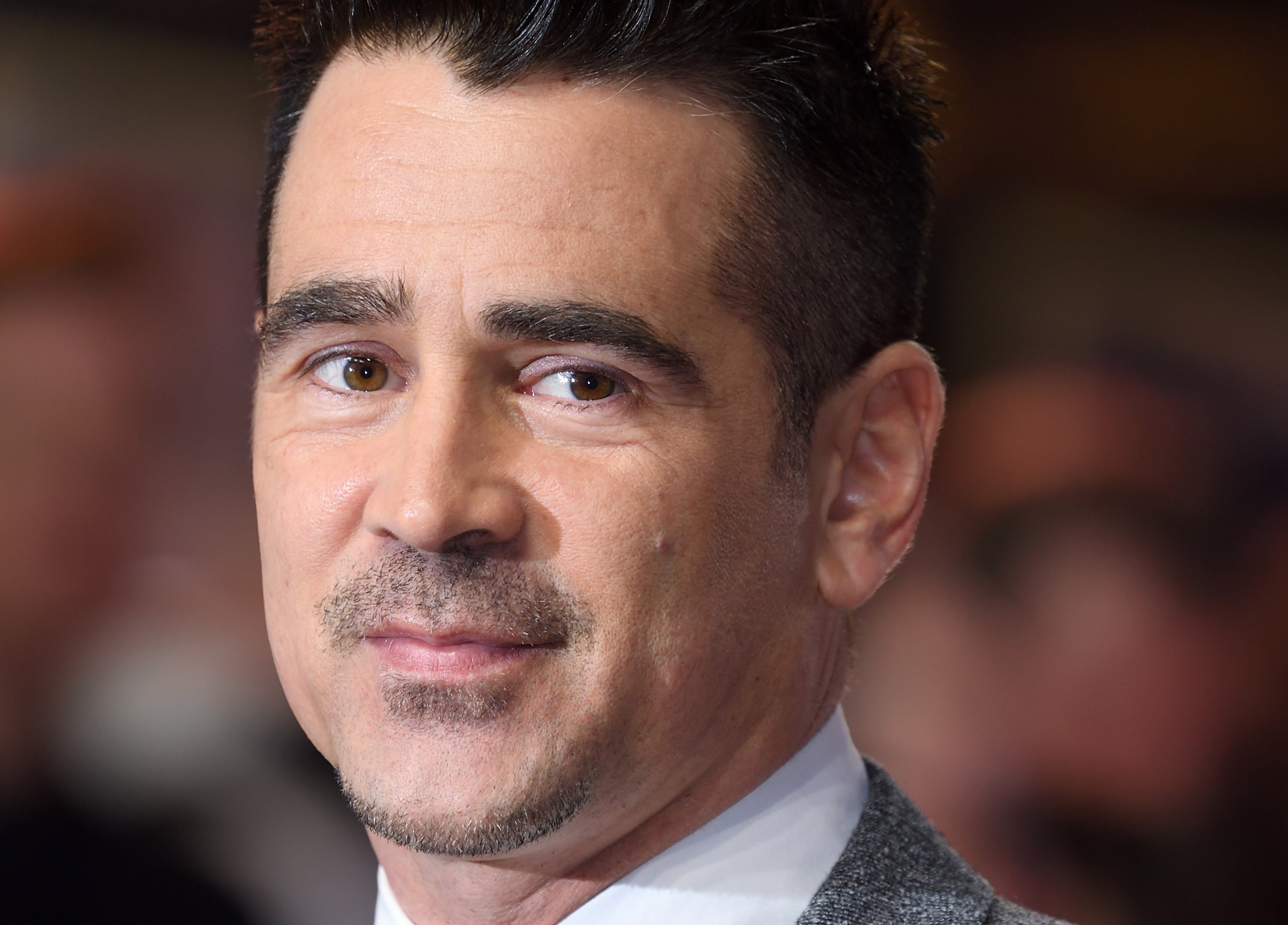 'The Batman' star Colin Farrell wears a gray suit over a white button-up shirt. Farrell will be reprising his role as Penguin from 'The Batman' in a television show on HBO Max.