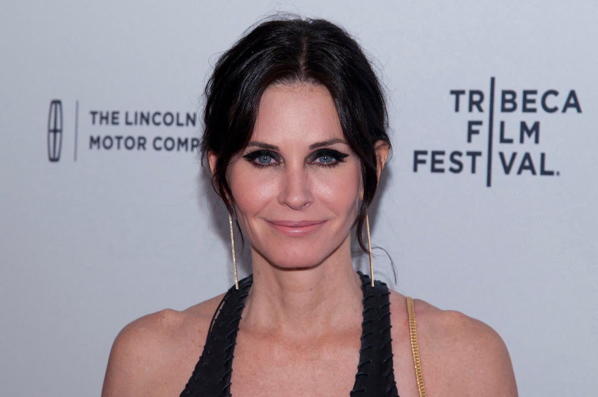 Courteney Cox smiles at an event.