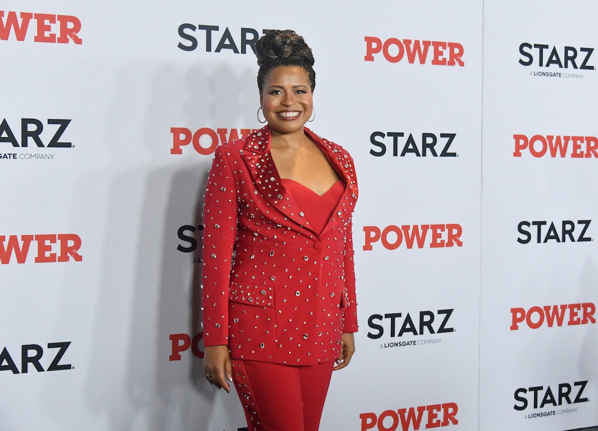 Courtney Kemp wears a red suit at a media event