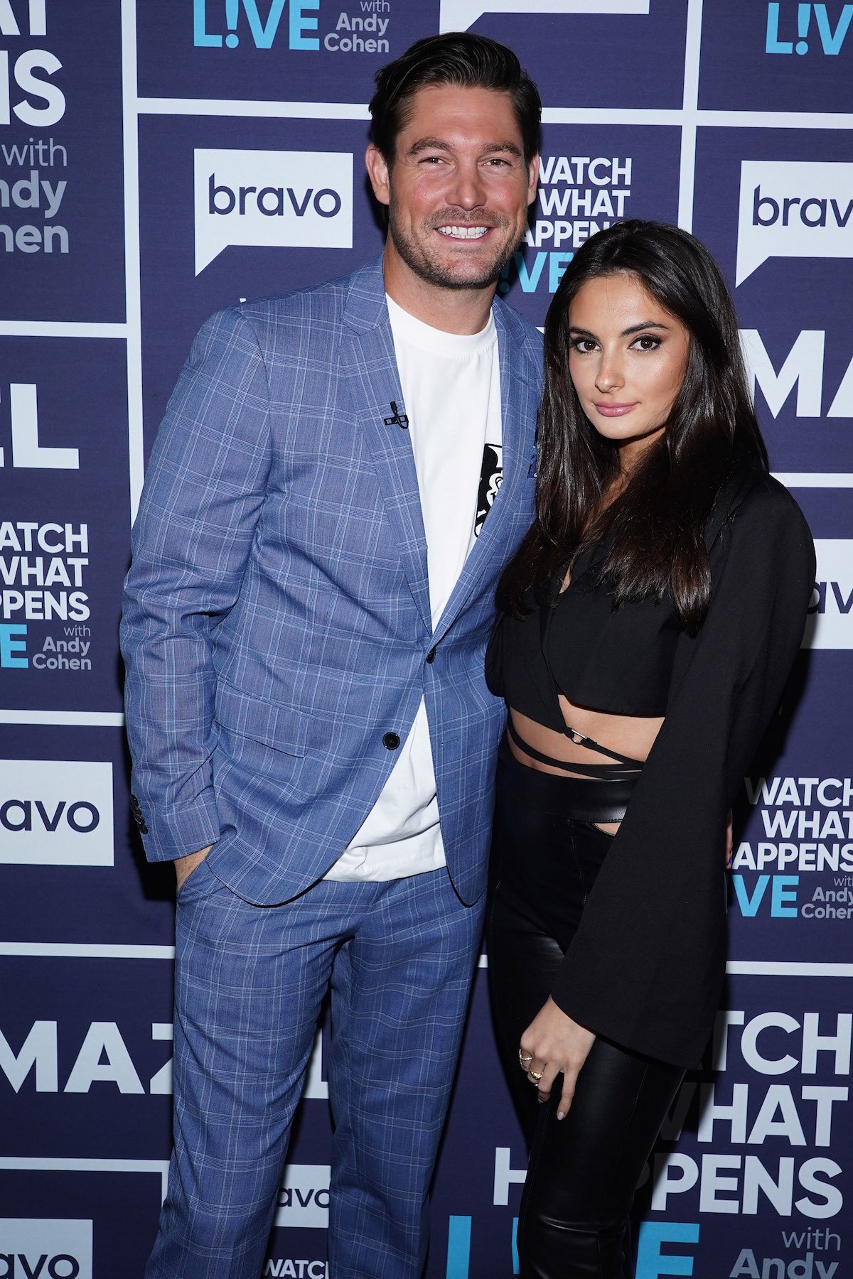 Craig Conover and Paige DeSorbo pose together at an event.