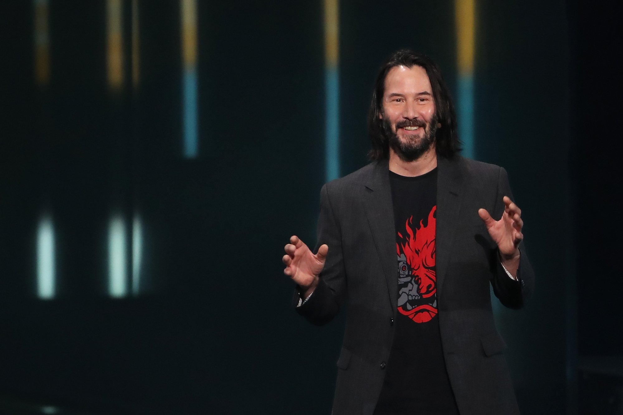 'Cyberpunk 2077' actor Keanu Reeves smiling and holding his hands up at game event