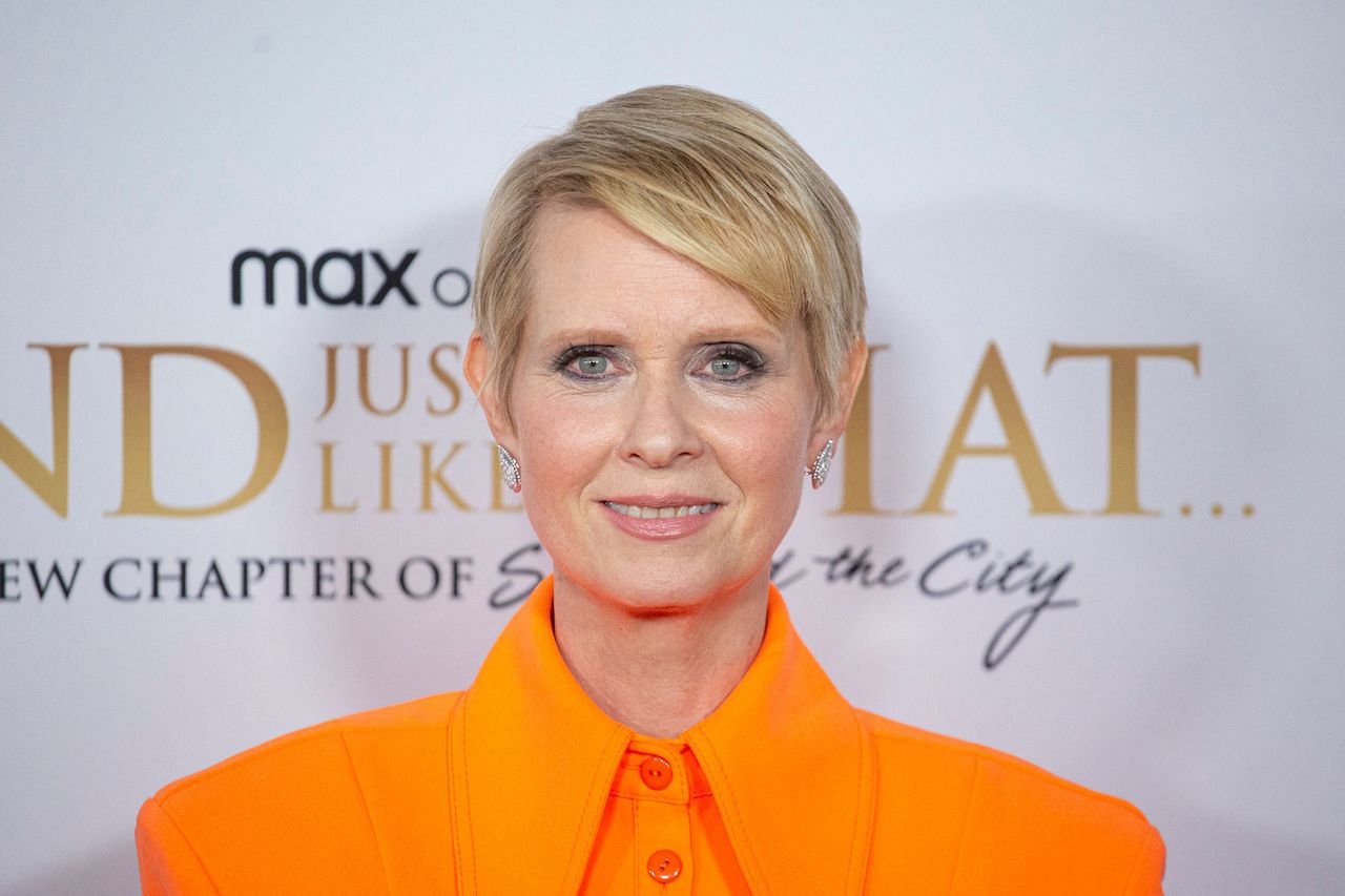 Cynthia Nixon attends HBO Max's "And Just Like That" in an orange outfit.