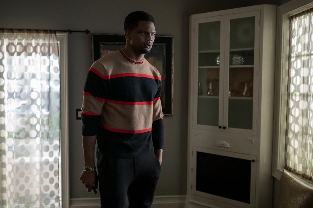 Daniel Bellomy as Zeke Cross wearing a sweater and standing in a dimly lit room in 'Power Book II: Ghost'