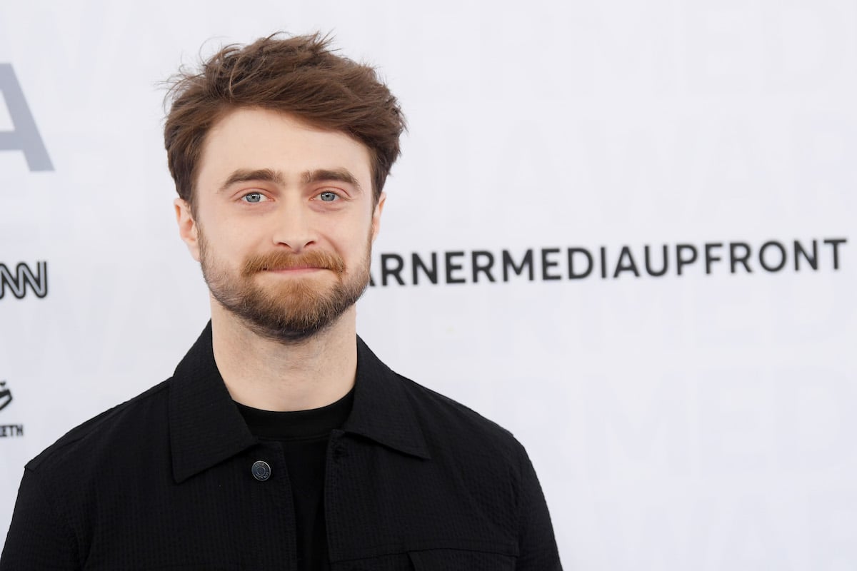 Daniel Radcliffe smiles at an event.