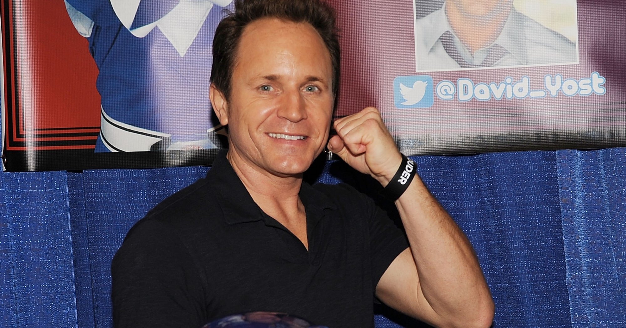 David Yost as Blue Ranger for 'Mighty Morphin Power Rangers' holding helmet and in fighting stance.