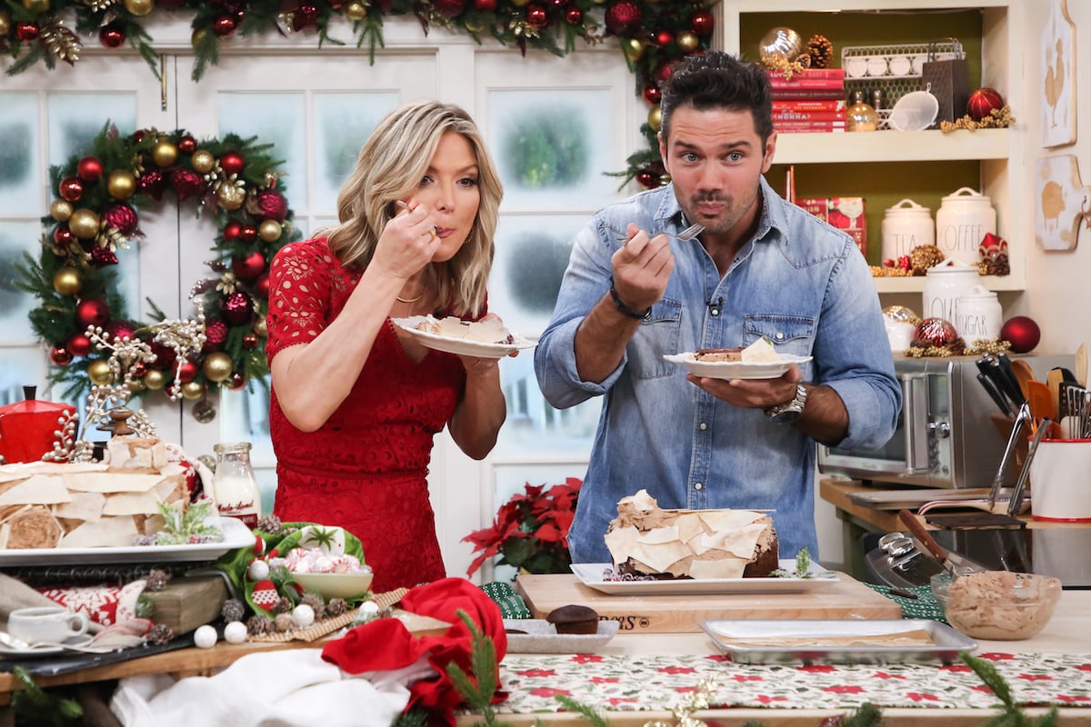 Debbie Matenopoulos and Ryan Paevey eat pieces of their buche de Noel cake during an episode of 'Home & Family'